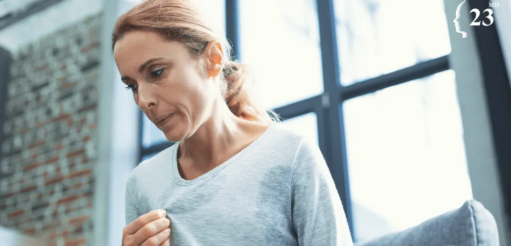 A woman looking out of a window illustrating an archived health article at 23MD