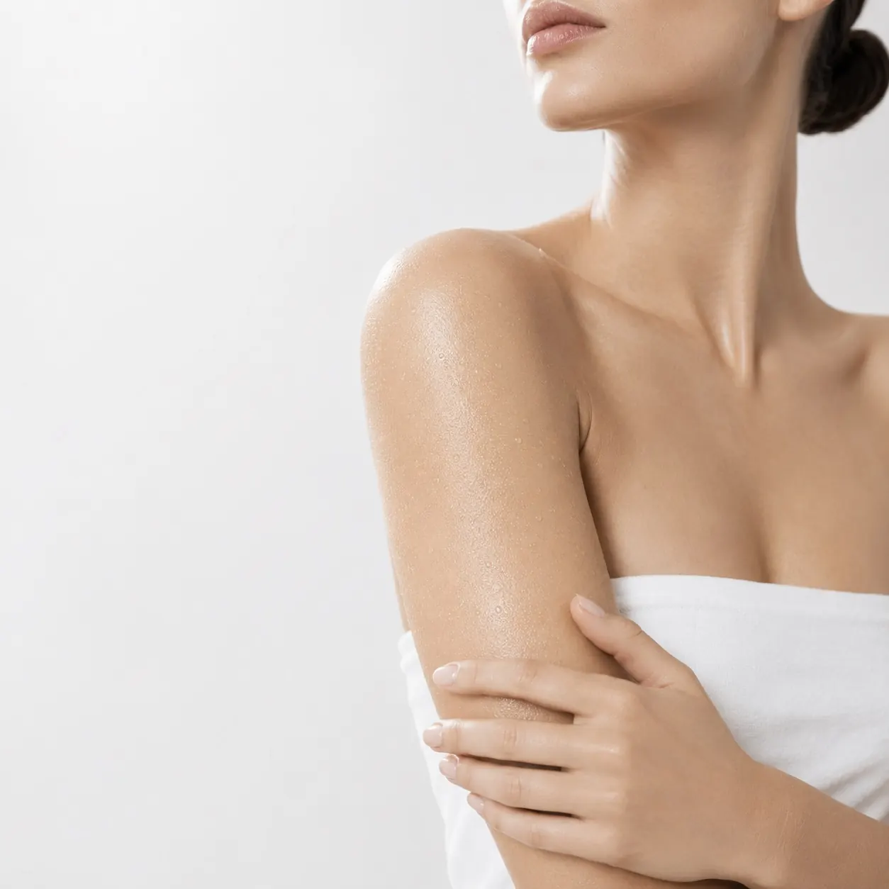 Close-up of a patient's arm and shoulder illustrating body skin treatment at 23MD