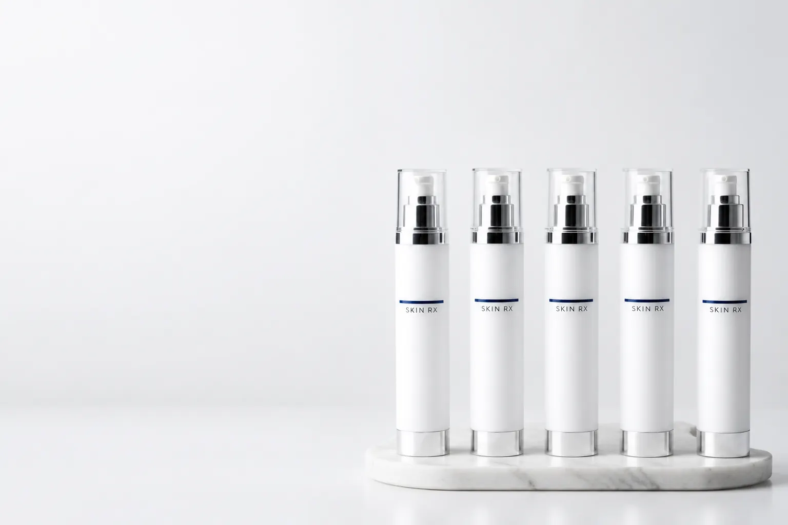 Five white pump bottles arranged in a row illustrating the face cream range at 23MD