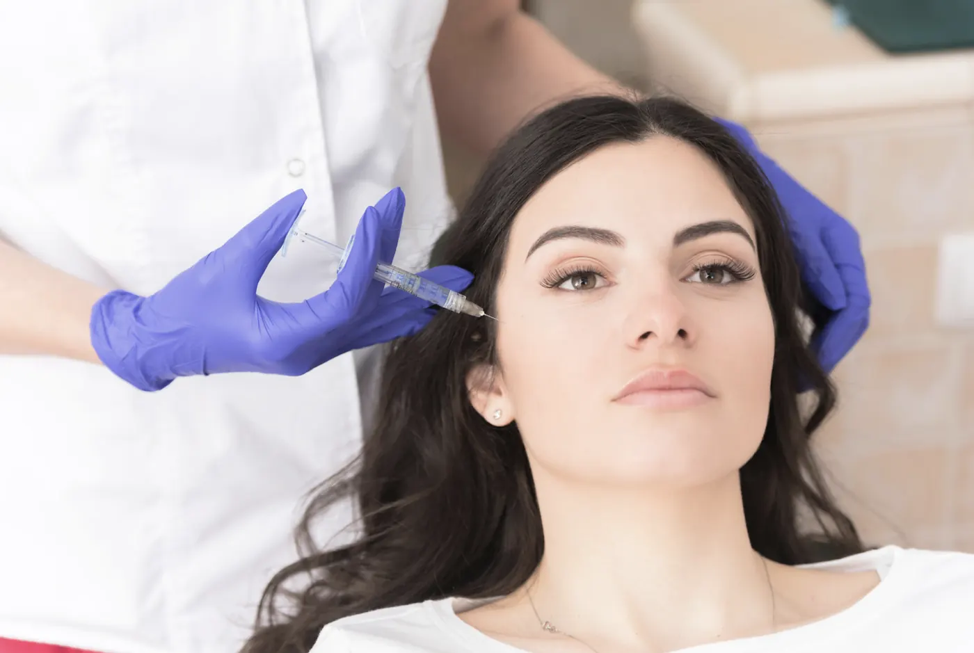 A gloved hand treating a patient's cheek illustrating an archived health article at 23MD