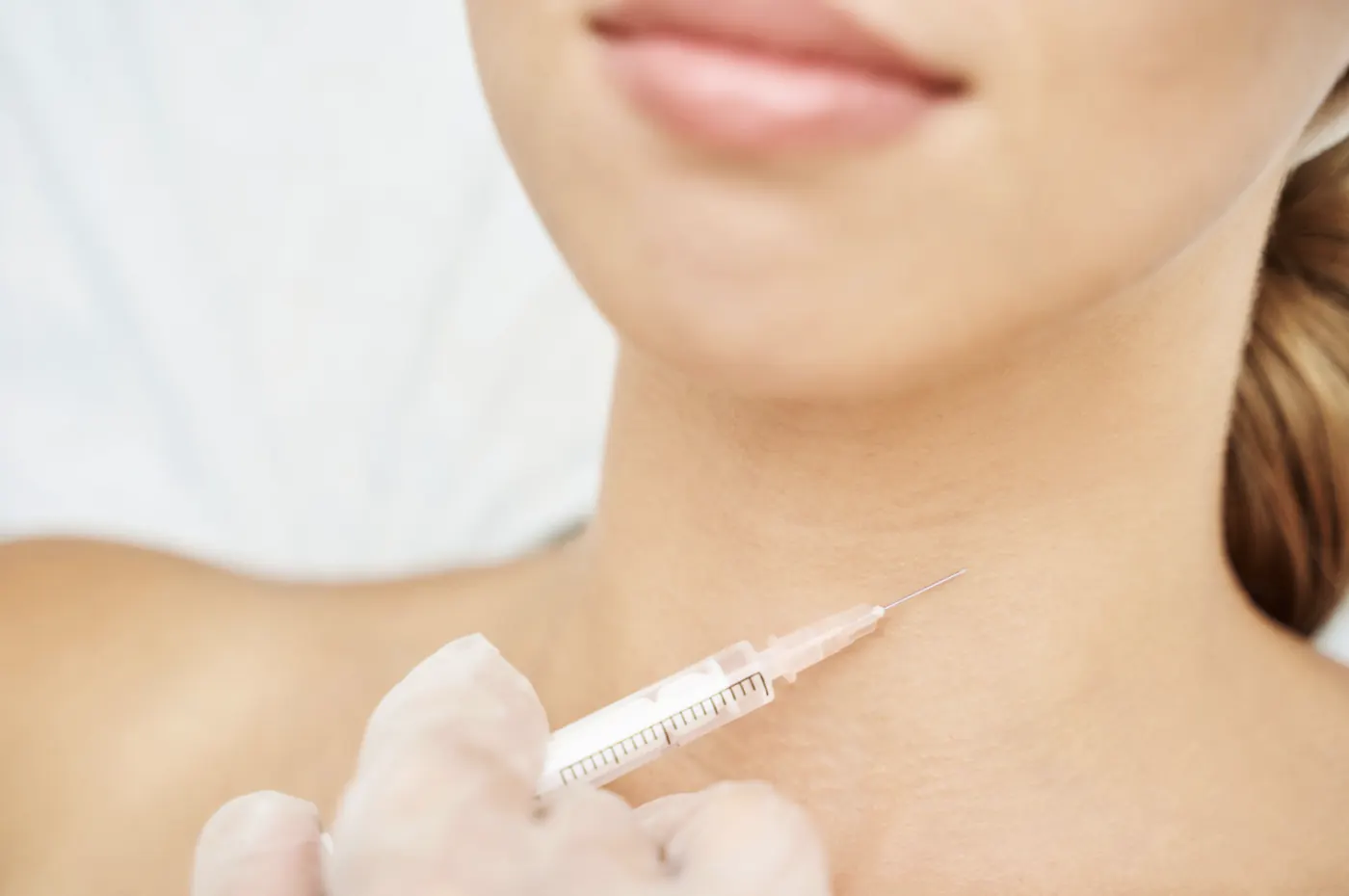 A syringe near a patient's neck illustrating an archived health article at 23MD