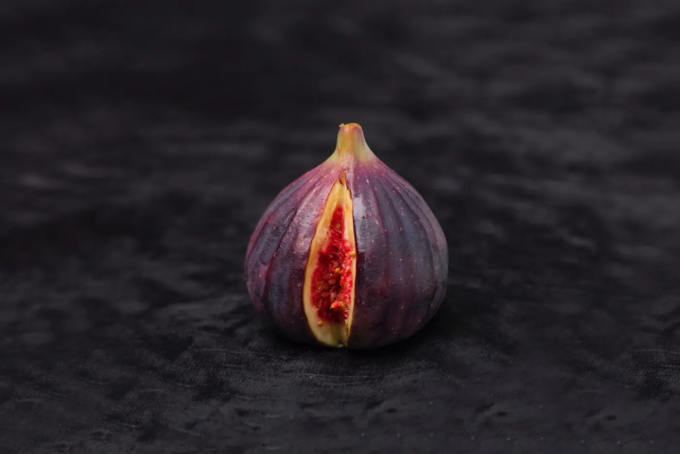 A halved fig on a dark surface illustrating an archived health article at 23MD